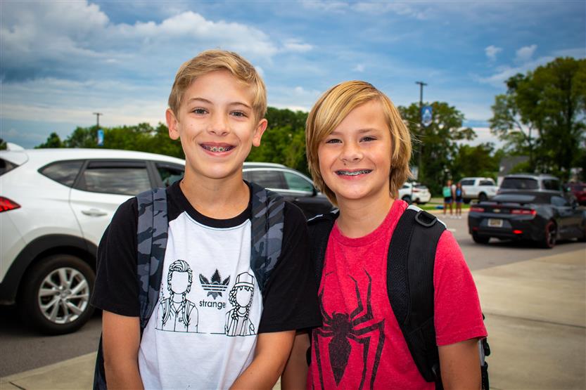 Two blond boys smile